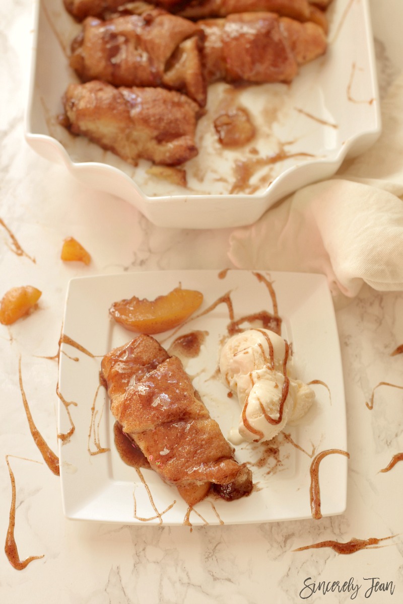 Easy Peach Dumplings - Simple and delicious dessert that combines peaches, crescent rolls, brown sugar, butter, vanilla, and cinnamon! Yum! www.SincerelyJean.com